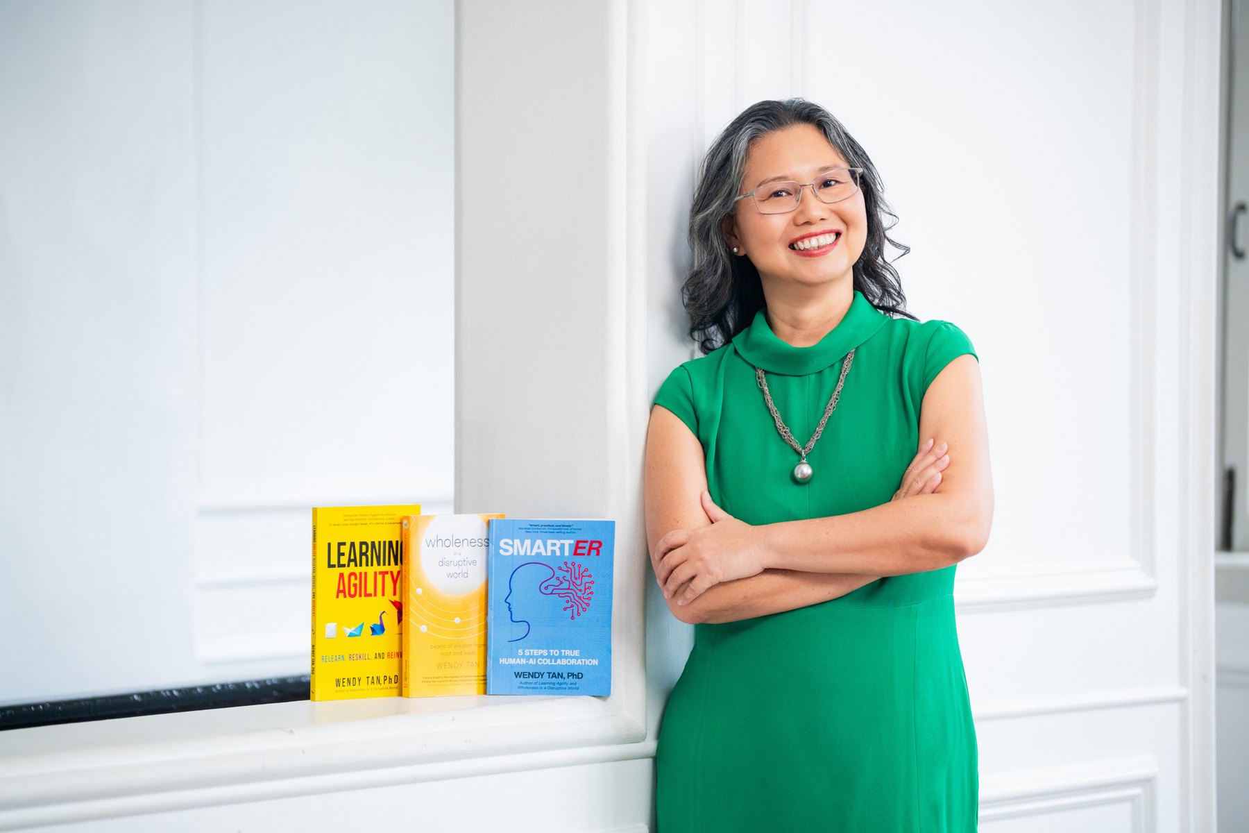 Wendy Tan with her three books — Learning Agility, Wholeness in a Disruptive World, and Smarter
