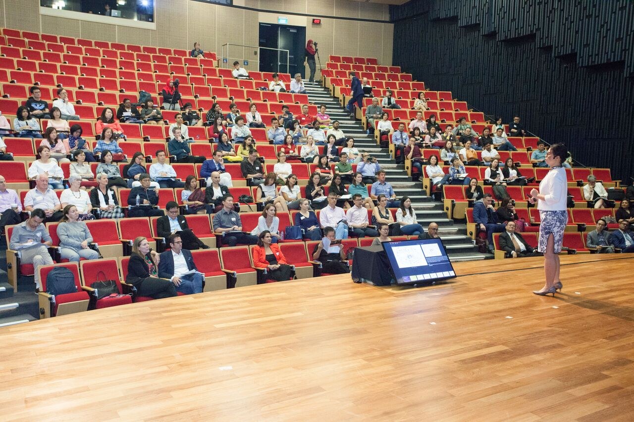 Wendy Tan on stage at a conference
