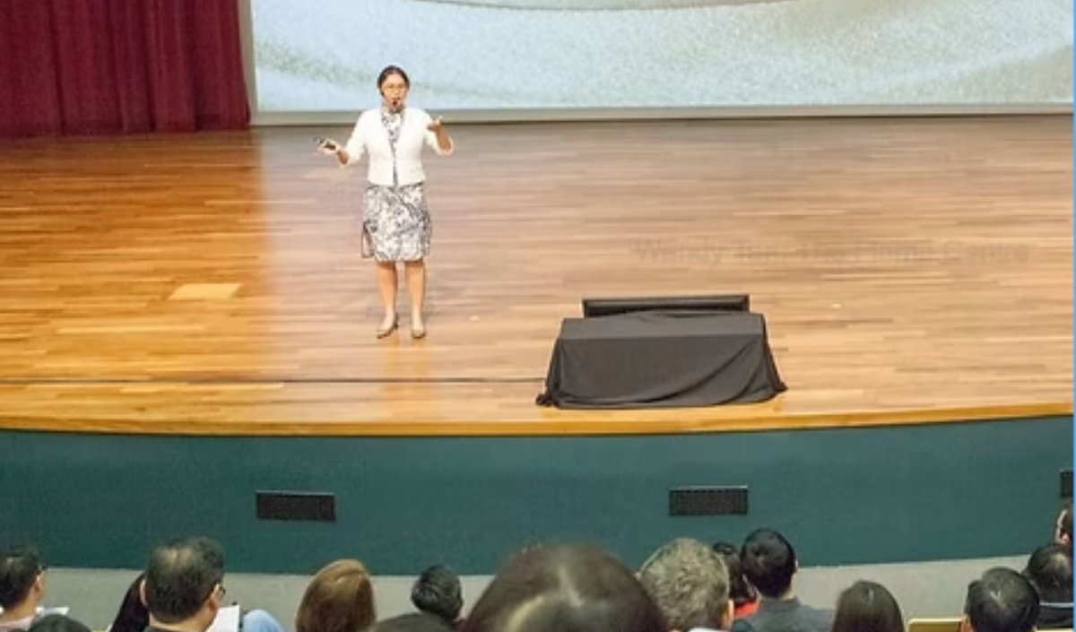 Wendy speaking at a conference